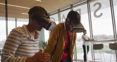 Creative Team Using VR Headsets in Modern Office Environment