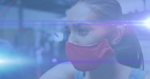 Focused woman wearing protective mask in futuristic setting