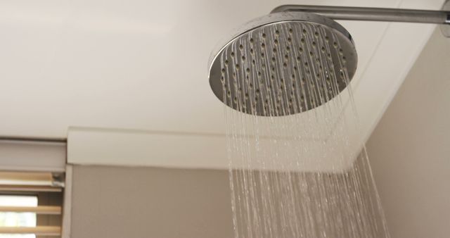 Close-up of shower head with flowing water in bathroom at home 4k