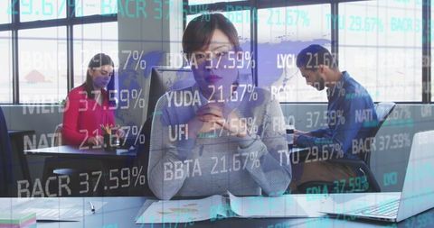 Asian businesswoman analyzing stock market data in office