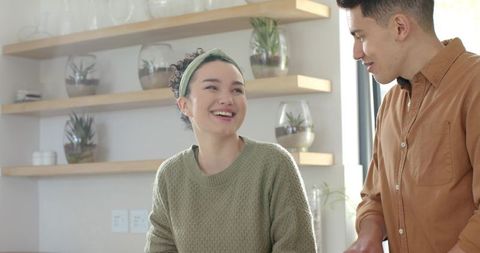 Happy couple chatting in cozy modern kitchen