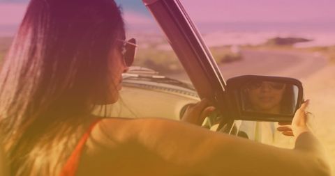 Woman Adjusting Car Mirror by Seaside at Sunset - Download Free Stock Images Pikwizard.com
