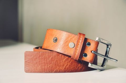 Closeup of Brown Leather Belt on Light Surface