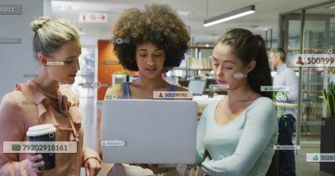 Three women collaborating on laptop with augmented reality overlays in office