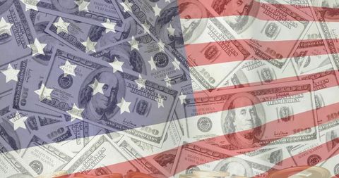American flag overlaying us hundred-dollar bills and coins financial concept montage