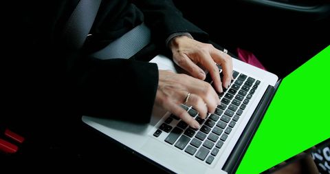 Businesswoman Typing on Laptop Inside Car on Business Trip