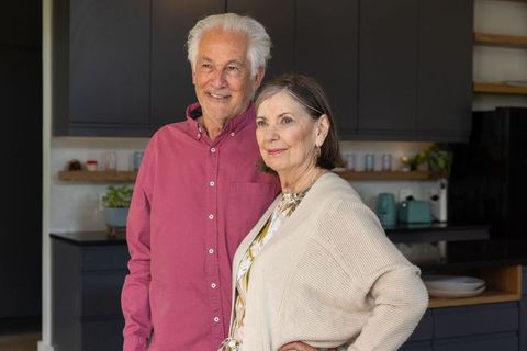 Senior Couple Smiling in Modern Kitchen Setting