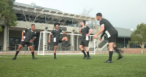Team Embracing Solidarity on Soccer Field