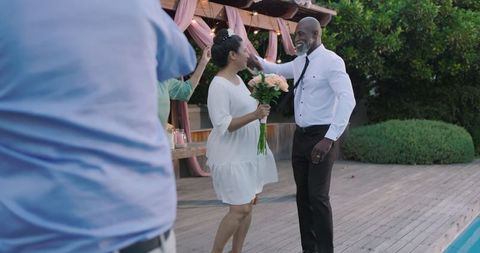Senior Diverse Couple Dancing Joyfully at Outdoor Wedding