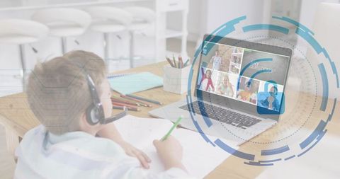 Young boy writing while joining virtual classroom on laptop with headset and HUD overlay