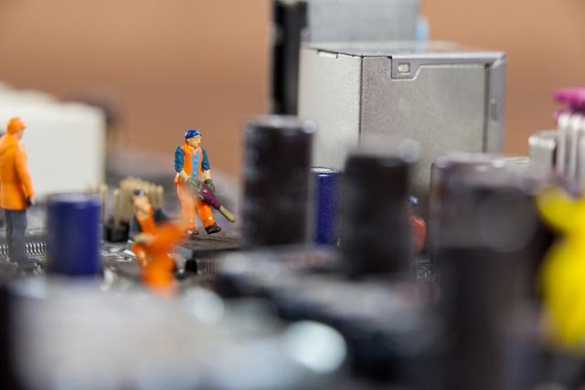 Miniature Workers Repairing Electronic Circuit Board - Download Free Stock Photos Pikwizard.com