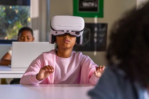 African american student wearing vr headset in classroom exploring virtual learning