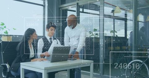 Diverse team collaborating on laptop with data visualization overlays in contemporary office
