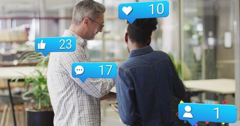 Colleagues checking social media notifications on smartphone in modern coworking office