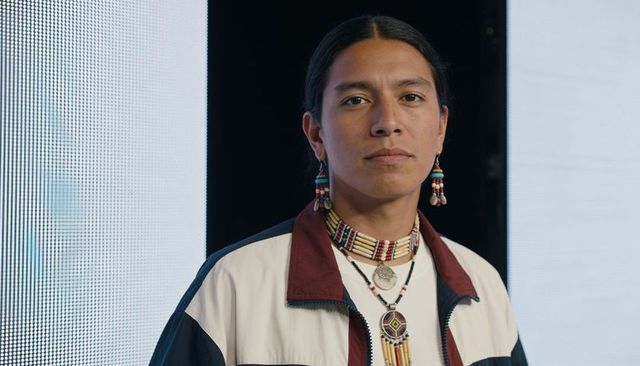 Native american man wearing beaded choker and earrings, modern studio portrait led panels