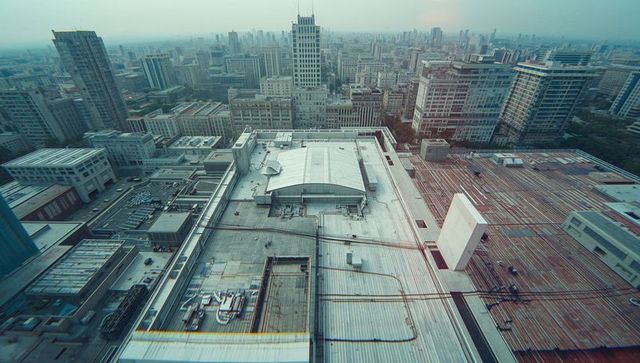 Urban rooftop view with hvac units and piping in city center