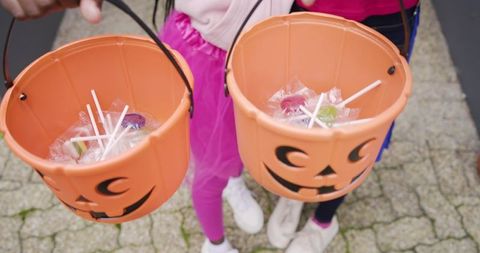 African American Girls Holding Jack-O'-Lantern Candy Buckets Wearing Tutus and White Sneakers