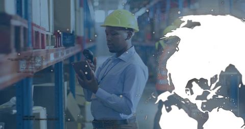 Warehouse logistics worker scanning inventory with tablet and scanner, global analytics overlay