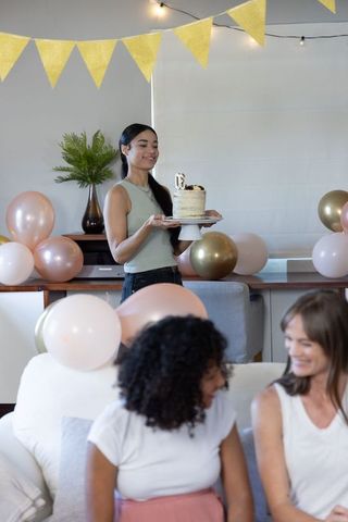 Friends Celebrating Birthday with Festive Decorations and Cake