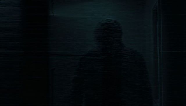 Mystery Figure in Dark Corridor with Static Overlay