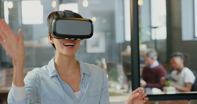 Woman Experiencing Virtual Reality in Office Environment - Download Free Stock Images Pikwizard.com