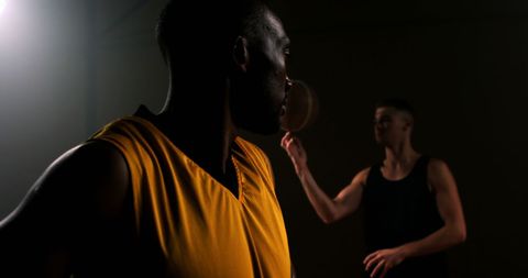Focused Basketball Players Training in Dark Gym - Download Free Stock Images Pikwizard.com
