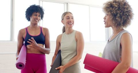 Diverse Women Chatting with Yoga Mats in Bright Studio - Download Free Stock Images Pikwizard.com