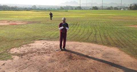 Baseball Player on Mound in Vintage Jersey by Field