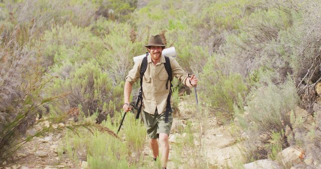 Middle-aged male hiker enjoying outdoor adventure in secluded wilderness. Perfect for themes related to outdoor activities, travel, adventure, tourism promotion, hiking equipment, lifestyle blogging, nature exploration.