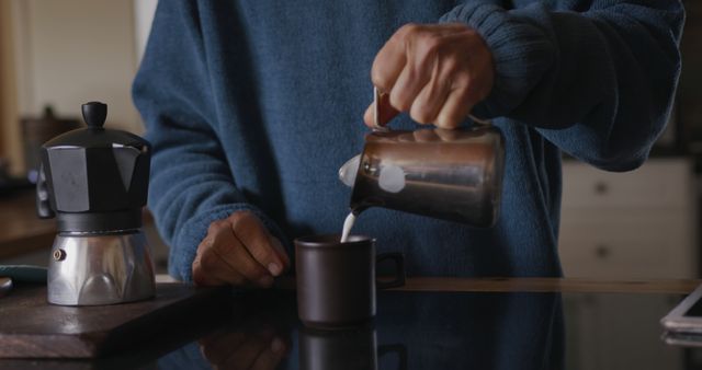 Person Pouring Milk Into Coffee Mug in Cozy Kitchen - Download Free Stock Images Pikwizard.com