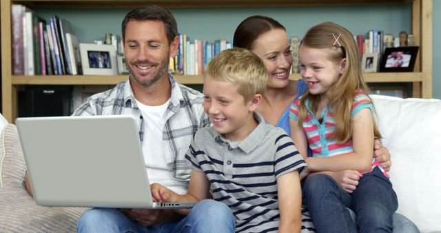 Happy Family Using Laptop on Couch in Living Room - Download Free Stock Images Pikwizard.com