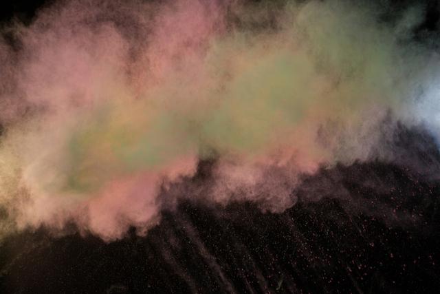 Vibrant explosion of colorful powder against a black background. Ideal for advertising, festival promotions, art projects, and creative designs looking to add a splash of color and energy.