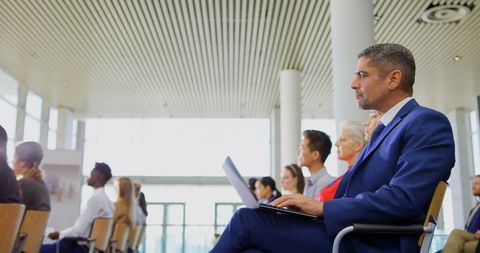 Businessman in thoughtful attentiveness at conference with laptop - Download Free Stock Images Pikwizard.com
