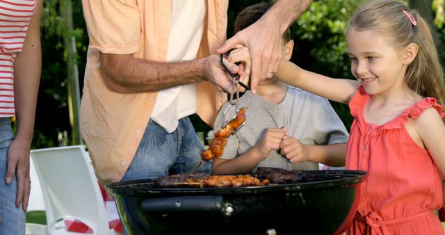 Family Enjoying Outdoor Barbecue Grill - Download Free Stock Images Pikwizard.com