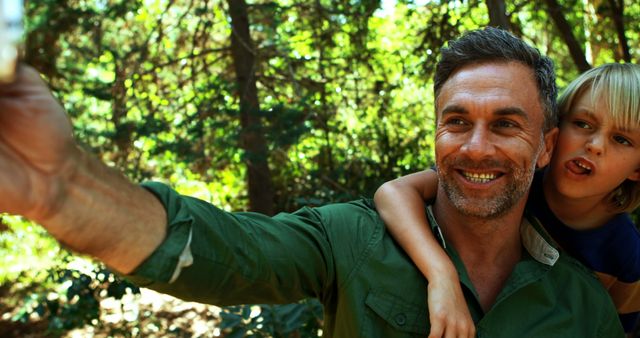 Joyful Father and Son Taking Selfie in Forest - Download Free Stock Images Pikwizard.com