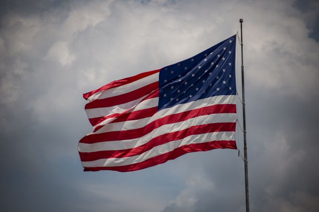Waving American Flag Against Cloudy Sky - Download Free Stock Photos Pikwizard.com