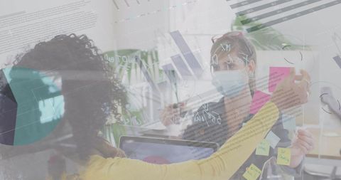 Colleagues Analyzing Digital Data with COVID-19 Safety Measures