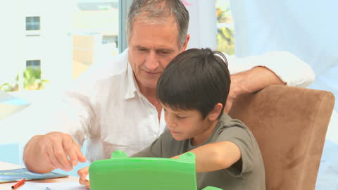 Grandfather Spending Quality Time with Grandson Doing Art at Home