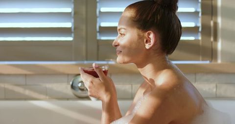 Serene Woman Enjoying Bubble Bath with Wine