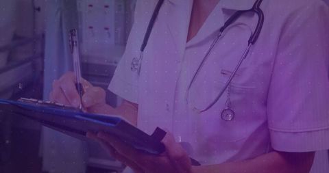 Nurse in Scrubs Writing on Clipboard in Hospital Environment