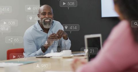 Smiling professional leading collaborative meeting with laptop and social media overlays