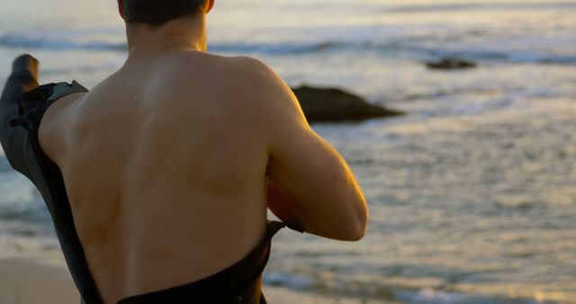 Surfer Wearing Wetsuit on Beach at Sunset - Download Free Stock Images Pikwizard.com