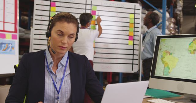 Customer Service Representative Working at Desk with Whiteboard in Background - Download Free Stock Images Pikwizard.com