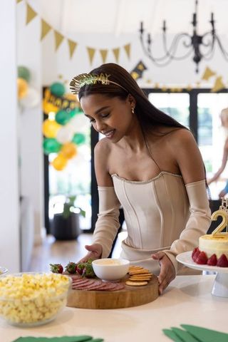Woman preparing elegant buffet for sophisticated home celebration