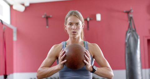 Woman using medicine ball in gym training exercise