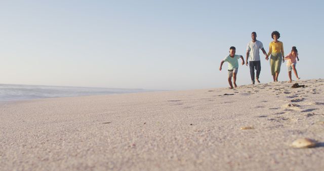 Happy African American Family Running on Sandy Beach by Ocean - Download Free Stock Images Pikwizard.com