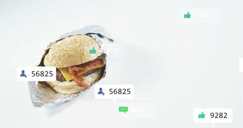Bacon cheeseburger wrapped in foil with social media like and follower badges