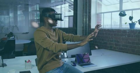 Developer using vr headset for virtual interaction in office environment