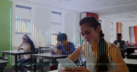 Focused teen girl engaged with digital tablet in classroom