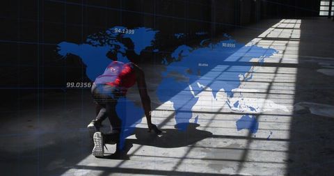 Crouching athlete launching sprint in industrial warehouse with global data overlay